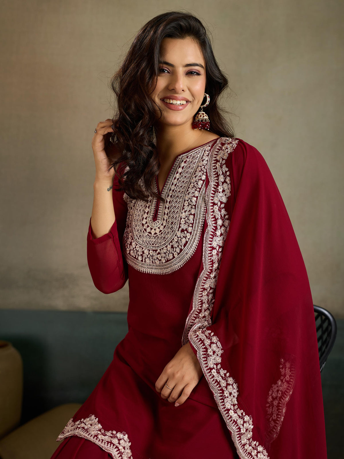 Maroon silver zari embroidered georgette kurta sharara set - close up seated shot neckline and dupatta embroidery detail