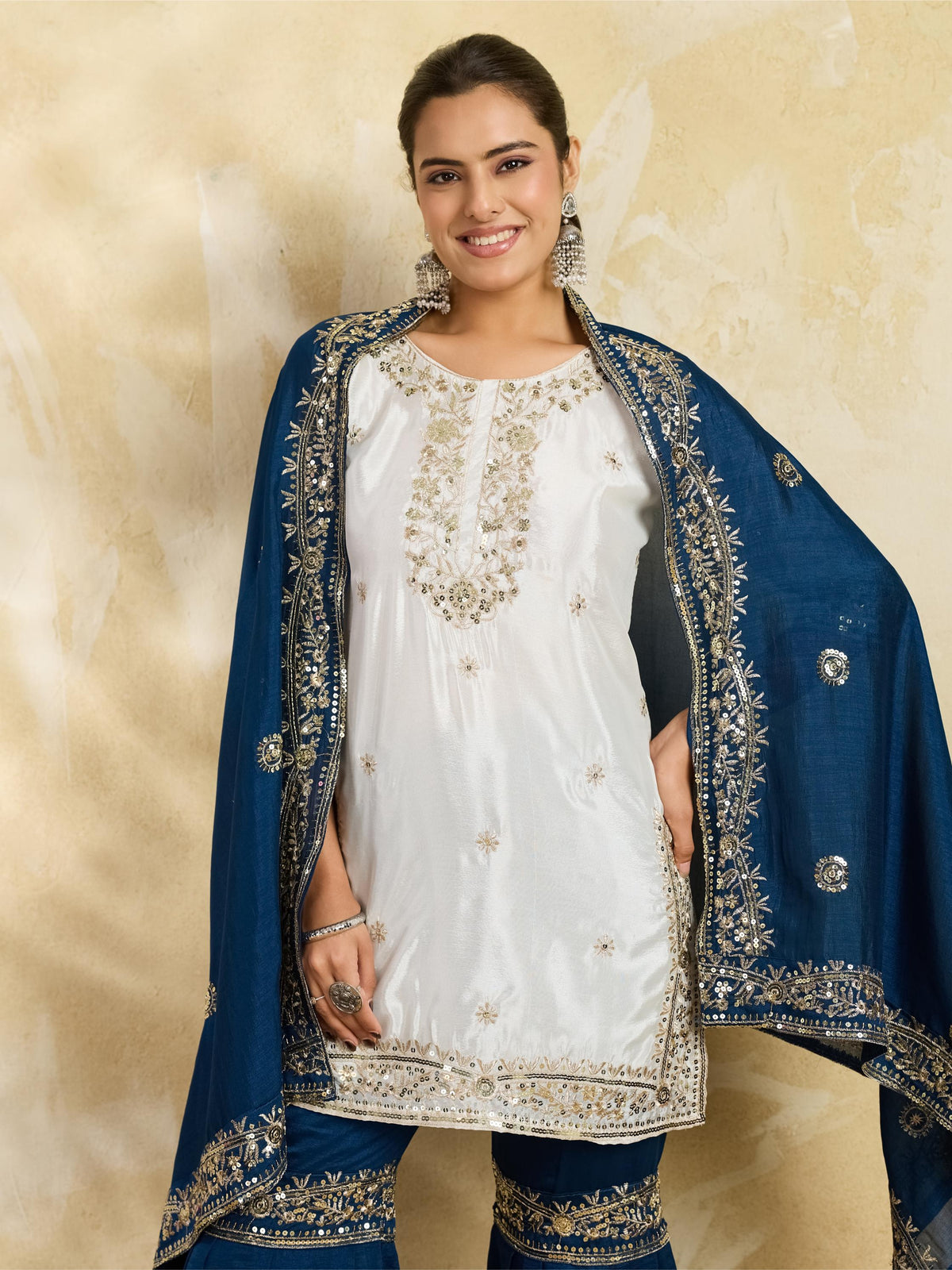 White and teal blue embroidered kurta sharara set - seated pose