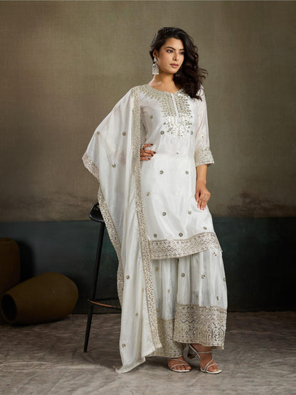 White silver sequin embroidered silk kurta palazzo set - seated side view with dupatta draped