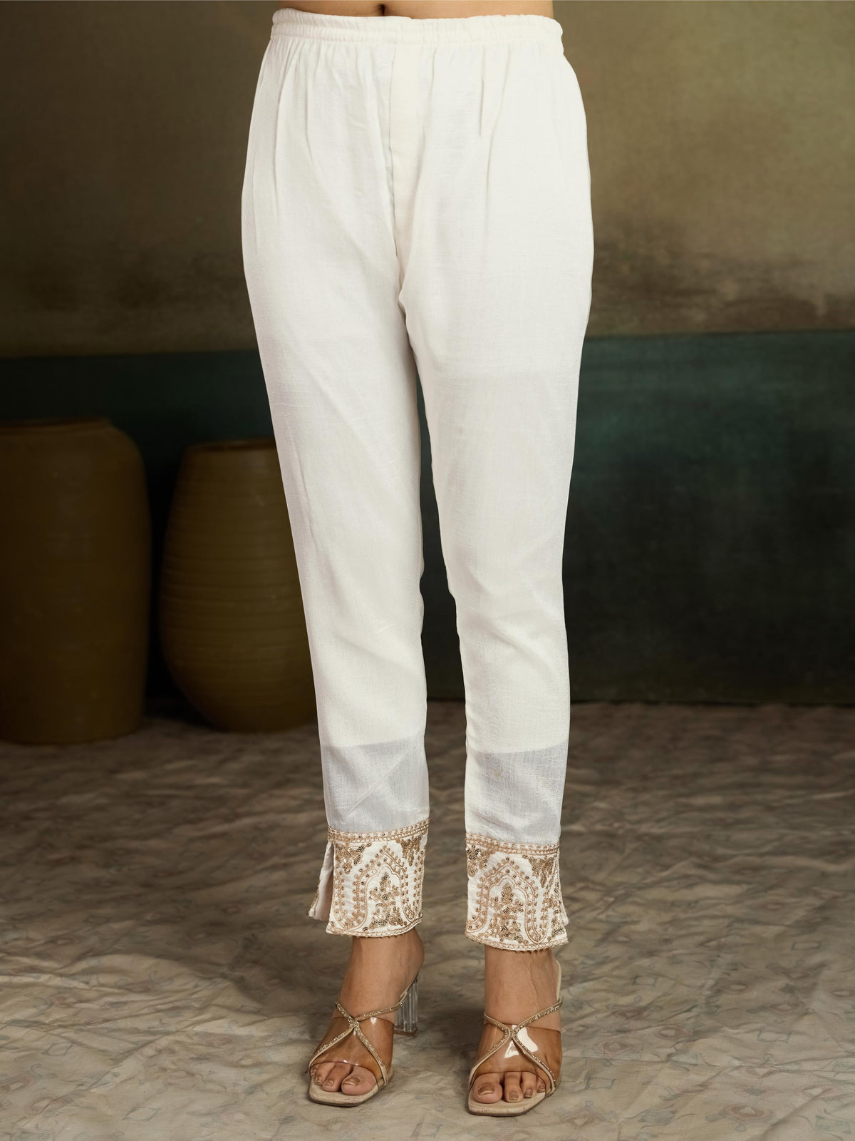 Ivory white gold zari embroidered silk kurta pant set - close up pants ankle embroidered paisley panel with tassel drops